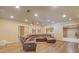 Spacious basement living area with a large sectional sofa, projector, and wood-look flooring at 110 Hawks Bnd, Canton, GA 30115