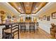 Basement bar area with wood ceiling, custom lighting, and ample seating at 110 Hawks Bnd, Canton, GA 30115