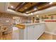 Basement bar area with brick accents, wood floors, granite counters and white cabinetry at 110 Hawks Bnd, Canton, GA 30115