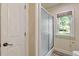 Bathroom view showcases a shower with sliding glass door and a window with natural light at 110 Hawks Bnd, Canton, GA 30115