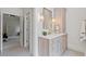 Well-lit vanity in a light, modern style, with double doors leading to bedroom and ensuite bathroom at 110 Hawks Bnd, Canton, GA 30115