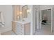 Well-lit vanity in a light, modern style, with double doors leading to bedroom and ensuite bathroom at 110 Hawks Bnd, Canton, GA 30115