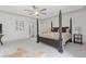 Spacious bedroom featuring a four-poster bed, a ceiling fan, and a cow hide rug at 110 Hawks Bnd, Canton, GA 30115