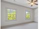 Large bedroom with a ceiling fan and windows looking out onto the trees at 110 Hawks Bnd, Canton, GA 30115