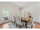 Cozy dining area with hardwood flooring, neutral walls, and a stylish chandelier above the table at 110 Hawks Bnd, Canton, GA 30115