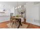 Open-concept dining area with views of the kitchen and staircase at 110 Hawks Bnd, Canton, GA 30115