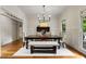 Bright dining room featuring wood floors, modern light fixture and a large table at 110 Hawks Bnd, Canton, GA 30115