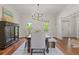 Open dining room with a table set for six, complemented by hardwood floors and neutral tones at 110 Hawks Bnd, Canton, GA 30115