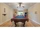 Well-lit game room featuring a pool table, wood paneled walls, and hardwood flooring at 110 Hawks Bnd, Canton, GA 30115