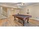 Spacious basement game room featuring wood floors and pool table at 110 Hawks Bnd, Canton, GA 30115