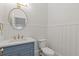 Stylish half bathroom featuring beadboard paneling, round mirror and blue vanity with white countertop at 110 Hawks Bnd, Canton, GA 30115