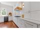 Well-lit kitchen featuring stainless steel appliances, white cabinets, light countertops, and wood accents at 110 Hawks Bnd, Canton, GA 30115