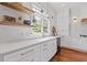 Bright kitchen featuring white cabinetry, stainless steel appliances, hardwood floors, and natural light at 110 Hawks Bnd, Canton, GA 30115