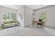 Bright living room with a green sofa, desk, two windows and plush carpeting at 110 Hawks Bnd, Canton, GA 30115