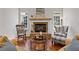 Cozy living room with fireplace, hardwood floors, and comfortable seating at 110 Hawks Bnd, Canton, GA 30115