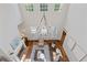 High-ceiling living room featuring a large chandelier, fireplace, and wood flooring, offering a luxurious feel at 110 Hawks Bnd, Canton, GA 30115