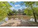 Peaceful pond with a wooden dock surrounded by lush greenery, creating a serene outdoor space at 110 Hawks Bnd, Canton, GA 30115