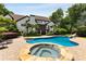 Beautiful in-ground pool and hot tub surrounded by well-manicured landscaping and mature trees at 110 Hawks Bnd, Canton, GA 30115