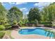Aerial view of the beautiful pool and backyard featuring lush landscaping, a water slide and spa at 110 Hawks Bnd, Canton, GA 30115