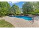 Relaxing outdoor swimming pool with slide and diving board, surrounded by lush landscaping at 110 Hawks Bnd, Canton, GA 30115