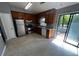 Functional kitchen with wood cabinets, stainless steel appliances, and a sliding door to the deck at 1310 Muirforest Way, Stone Mountain, GA 30088