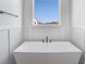 Bathroom features a modern soaking tub with black matte hardware and wainscoting at 180 Paislee Park (Lot #9 Paislee Park) Dr, Fayetteville, GA 30215