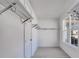 Walk-in closet with custom shelving, rods, and a view of the neighborhood at 180 Paislee Park (Lot #9 Paislee Park) Dr, Fayetteville, GA 30215