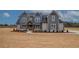 Charming home featuring a gray exterior, landscaped yard, and inviting entryway at 180 Paislee Park (Lot #9 Paislee Park) Dr, Fayetteville, GA 30215
