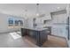 Modern kitchen features a large center island, stainless appliances, pendant lighting, and plentiful natural light at 180 Paislee Park (Lot #9 Paislee Park) Dr, Fayetteville, GA 30215