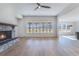 Open living room with stone fireplace and many windows at 180 Paislee Park (Lot #9 Paislee Park) Dr, Fayetteville, GA 30215