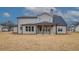 Rear exterior showcasing a covered patio and large backyard at 180 Paislee Park (Lot #9 Paislee Park) Dr, Fayetteville, GA 30215