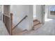 Bright staircase features carpeted steps, wooden handrail, and iron balusters at 180 Paislee Park (Lot #9 Paislee Park) Dr, Fayetteville, GA 30215