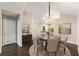 Elegant dining room with dark wood floors, chandelier, and circular rug at 15104 Harvest Ridge Ln, Alpharetta, GA 30022