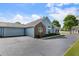 Well-maintained exterior featuring a attached garage, brick facade, and green space at 15104 Harvest Ridge Ln, Alpharetta, GA 30022