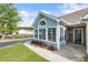 Charming home featuring an enclosed sunroom, flower beds and a well-manicured lawn at 15104 Harvest Ridge Ln, Alpharetta, GA 30022