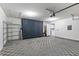Spacious garage with an epoxy floor, built in shelving and storage cabinets at 15104 Harvest Ridge Ln, Alpharetta, GA 30022