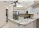 Modern kitchen featuring stainless steel appliances, white cabinets, granite countertops and tile backsplash at 15104 Harvest Ridge Ln, Alpharetta, GA 30022