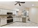 Updated kitchen with stainless appliances, white cabinetry, granite counters and tile flooring at 15104 Harvest Ridge Ln, Alpharetta, GA 30022