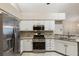 Modern kitchen with stainless steel appliances, white cabinets, and granite countertops at 15104 Harvest Ridge Ln, Alpharetta, GA 30022