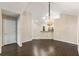 Spacious living room featuring dark wood floors and elegant chandelier at 15104 Harvest Ridge Ln, Alpharetta, GA 30022