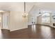 Spacious living area with hardwood floors, high ceilings, fireplace, and adjoining kitchen at 15104 Harvest Ridge Ln, Alpharetta, GA 30022