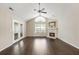 Bright living room with a ceiling fan, vaulted ceiling, stone fireplace, and hardwood floors at 15104 Harvest Ridge Ln, Alpharetta, GA 30022