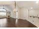 Open-concept living area with a stone fireplace, hardwood floors, vaulted ceilings and breakfast bar at 15104 Harvest Ridge Ln, Alpharetta, GA 30022