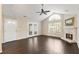 Bright living room with a ceiling fan, vaulted ceiling, stone fireplace, and hardwood floors at 15104 Harvest Ridge Ln, Alpharetta, GA 30022
