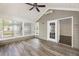 Inviting sun room with wood-look flooring, multiple windows, and lots of natural light at 15104 Harvest Ridge Ln, Alpharetta, GA 30022