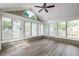 Sunroom with many windows, wood-look flooring and ceiling fan at 15104 Harvest Ridge Ln, Alpharetta, GA 30022