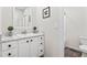 Neat bathroom with a single sink, white cabinets, and clean white toilet at 1924 Browns Mill Se Rd, Atlanta, GA 30315