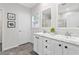 Stylish bathroom features double sinks with marble countertops and white cabinets at 1924 Browns Mill Se Rd, Atlanta, GA 30315