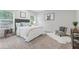 Inviting bedroom with plush carpet, soft bedding, and windows that provide natural light at 1924 Browns Mill Se Rd, Atlanta, GA 30315