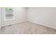 Bright bedroom featuring neutral carpet, white walls, and a window to bring in the natural light at 1924 Browns Mill Se Rd, Atlanta, GA 30315